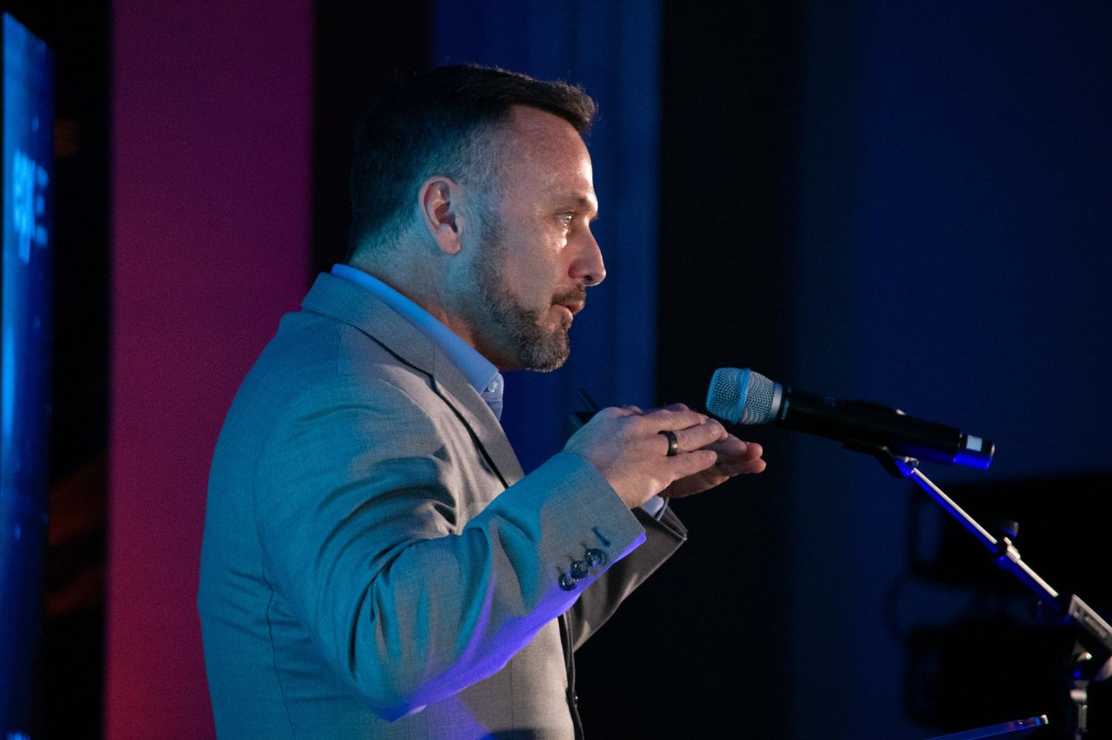 Dr. Allan Stewart giving a talk on stage