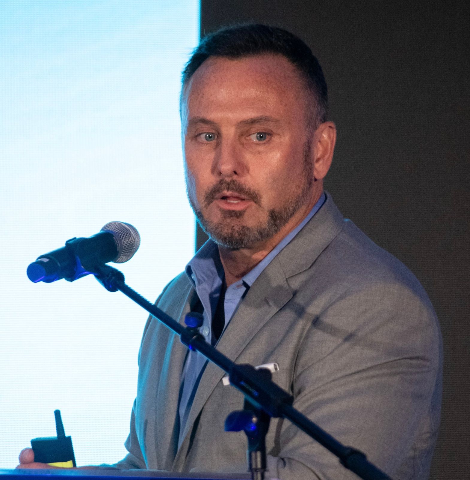Dr. Allan Stewart speaking at a podium